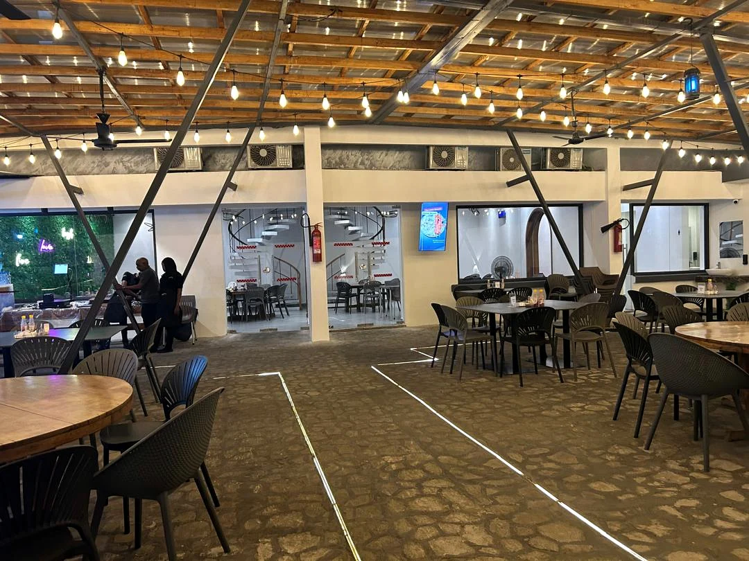 Actual Bali’s & Co. dining area with illuminated timber canopy